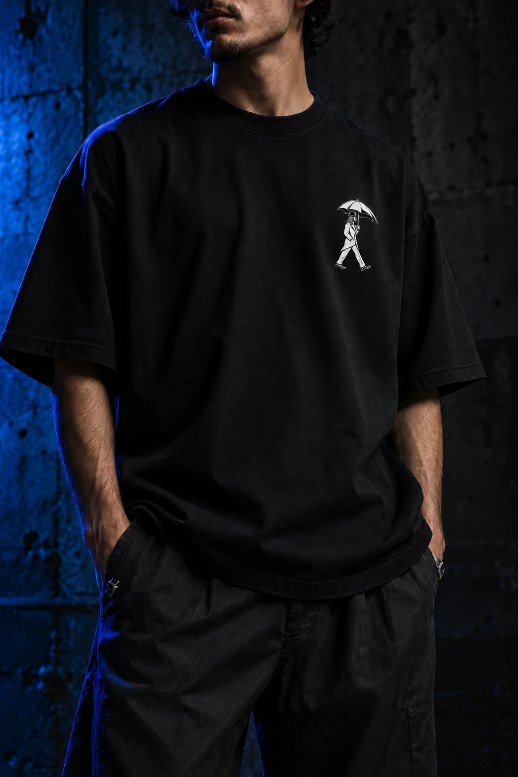 Streetwear campaign concept: oversized black tee with the white gentleman-and-umbrella logo